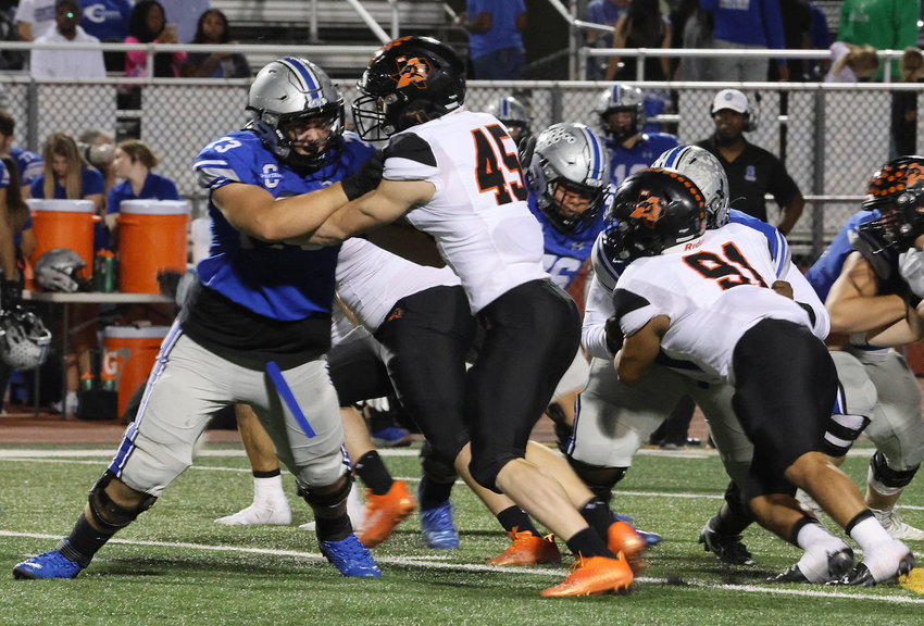 Kenneth Lohmer (45) and Matt Gonzales (91) pressure the Burleson offensive line.