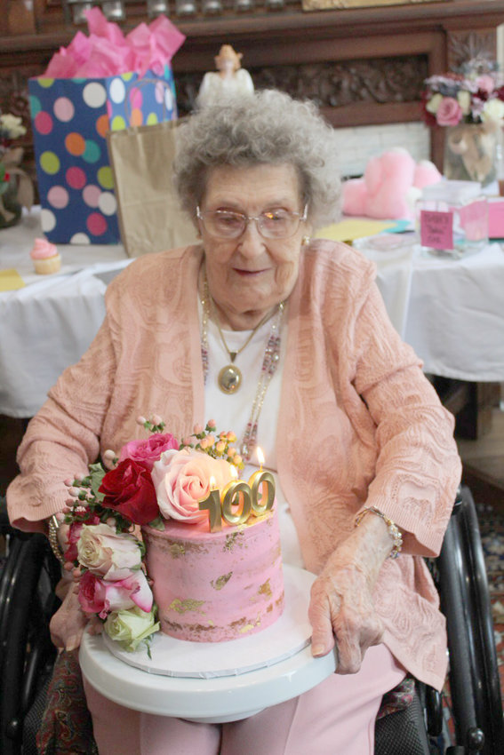 Claire Whisenant shows off her 100th birthday cake.