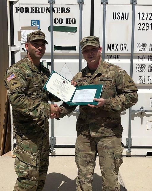 Ashton Johnson, right, receives recognition from the U.S. Army.