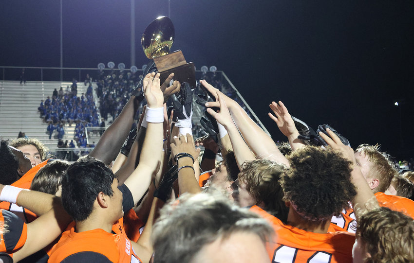 The Bearcats hold up the district championship trophy after defeating Brewer 47-6 at home to close out district.
