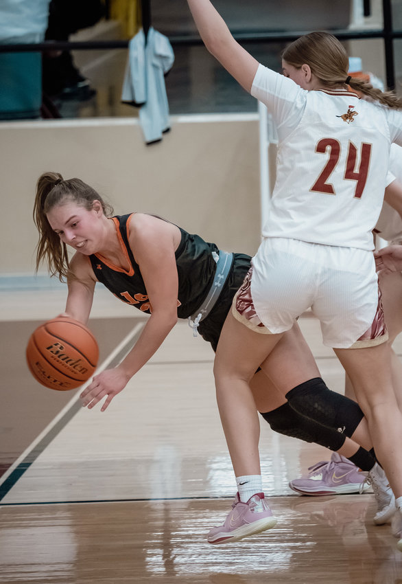 Presley Hull is tripped up at the low post against Saginaw.