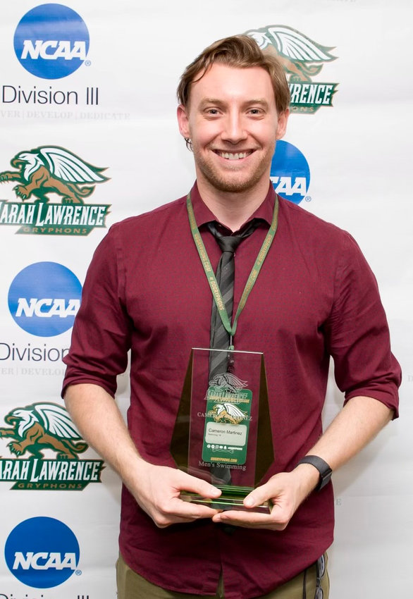 Cameron Martinez shows his trophy received as a commemoration of his listing in the Sarah Lawrence College Athletic Hall of Fame.