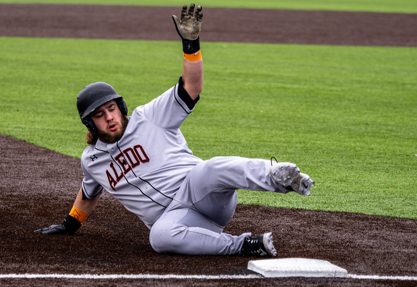 Bearcats designated hitter Andrew Cambre slides safely into third base during the fifth inning of the game against Arlington Martin on Saturday, Feb. 25. Cambre doubled to left center in the inning, driving in the winning run for Aledo.