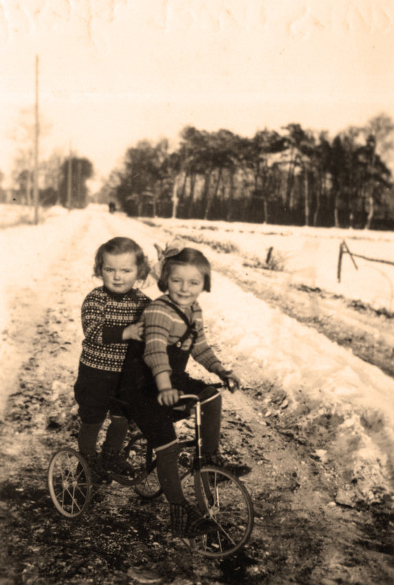 Hans Schwantje rides on the tricycle his sister 'Katie' Gisela 'found' up against a tree in their yard this Christmas morning, 1940.  WWII was about to consume their lives, and gifts like this would no longer be possible.  Sadly, this photo was taken only 27 days after their dad died at age 35.