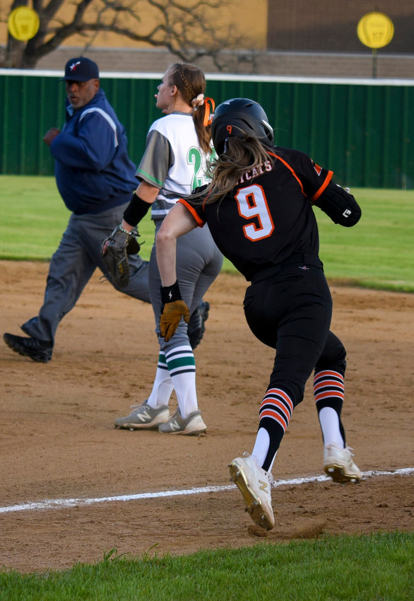Addie Perry runs to first base to get the game started against the Azle Hornets on March 21.