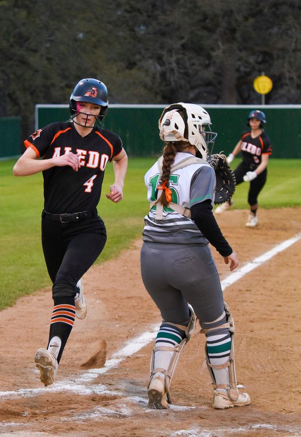 Chloe Cox runs home and is followed by Liliana Flores who rounds third. Both Ladycats scored against the Azle Hornets on March 21.