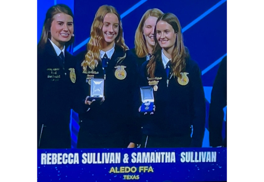 Twins Rebecca (left) and Samantha Sullivan are shown on the big screen at the Houston Livestock Show..