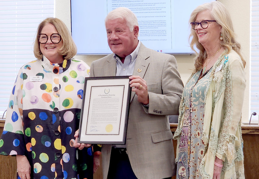 Willow Park Mayor Doyle Moss presents a proclamation honoring Freedom House in recognition of April being Sexual Assault Awareness Month to Freedom House Executive Director Patti Wilson (left) and Sexual Assault Advocate Donna Chambers during Tuesday's Willow Park City Council meeting.
