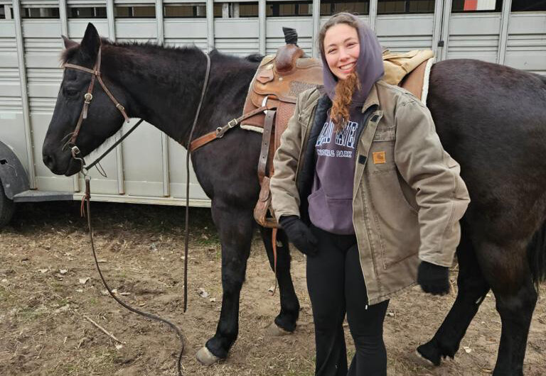Elena is shown riding horseback in Kansas.