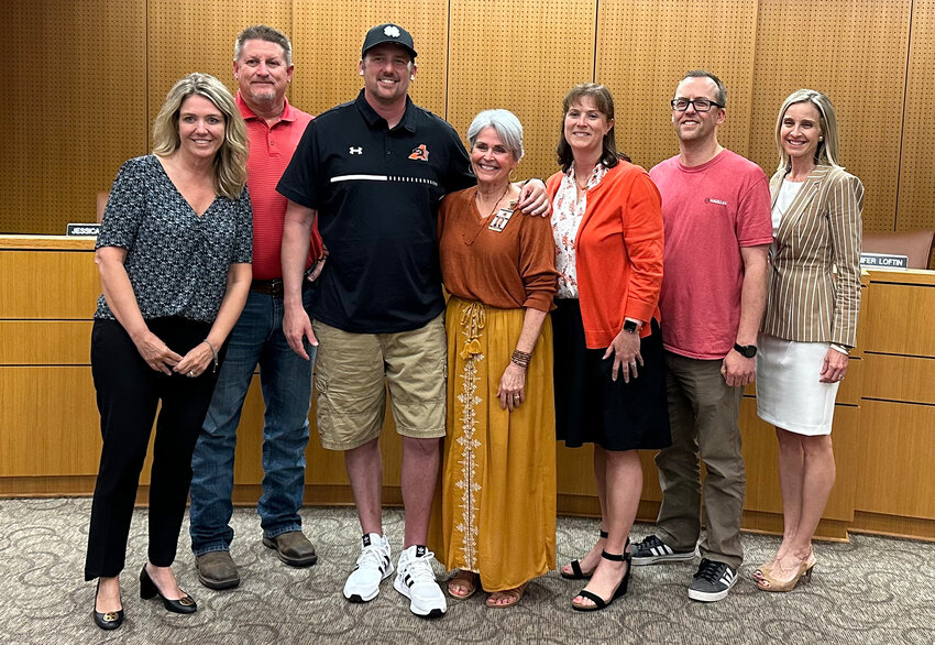 Lynn McKinney (center) is shown with school board members Julie Turner, Hoyt Harris, Forest Collins, Jennifer Taylor, and David Lear, and Superintendent Dr. Susan Bohn..