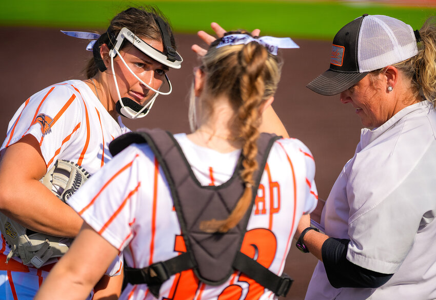 Ladycats Nathalie Touchet and Allison Mallard meet on the mound with Coach Heather Myers during Aledo's 13-1 rout of Azle during Senior Night.