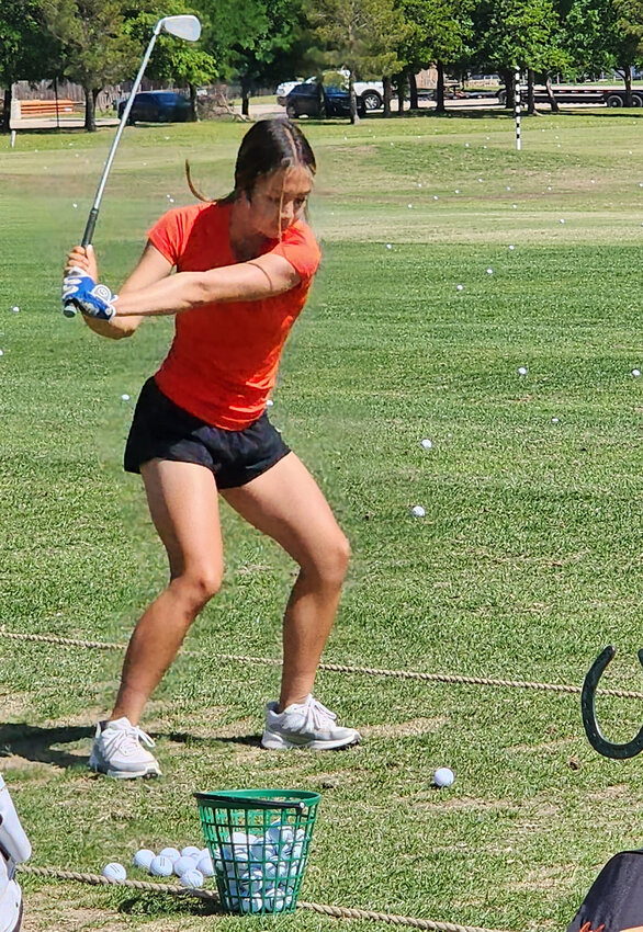 Junior Kyla Morales takes some practice swings in preparation for the state tournament.