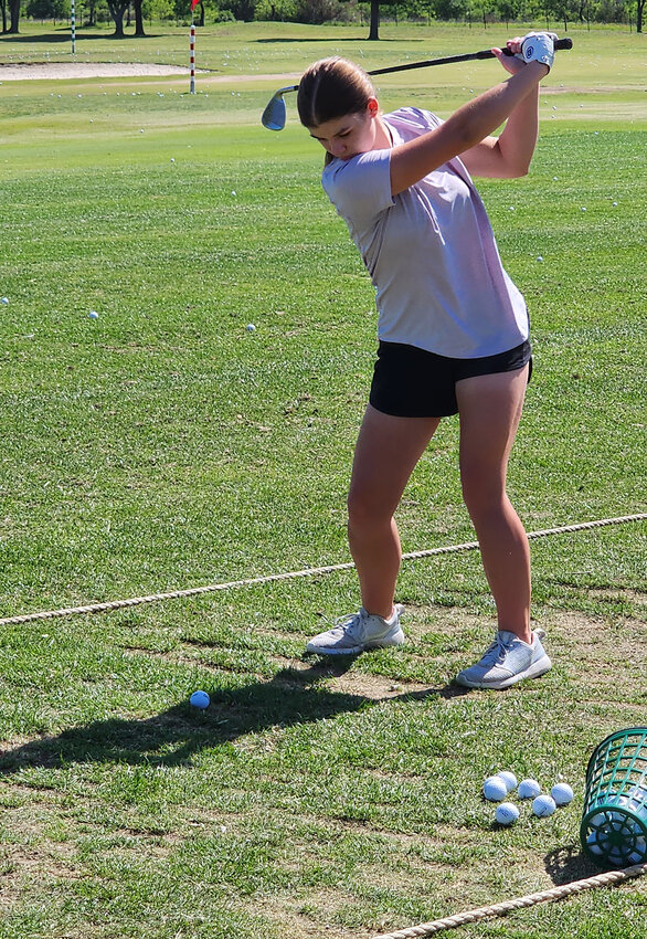 Freshman Emily Crick works on her swing prior to state.