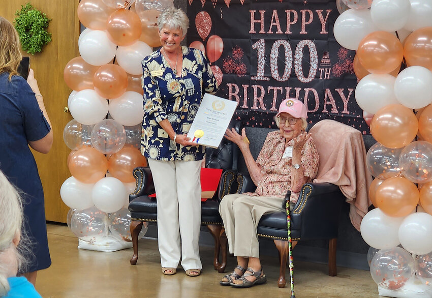 Jean Buford is overwhelmed at the attention surrounding her 100th birthday as Judy Flanigan from State Senator Phil King's office honors her.