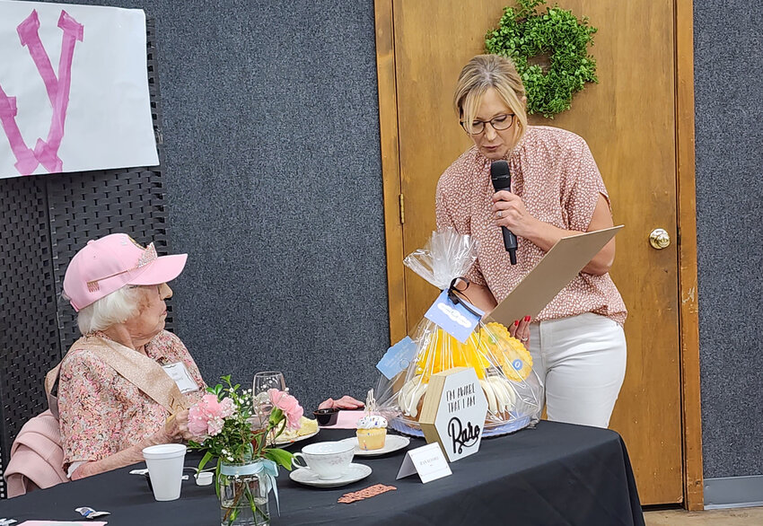Jennifer Bledsoe, Director of Operations for Parker County Committee on Aging, reads a special birthday card to Jean Buford, who was celebrating her 100th birthday.