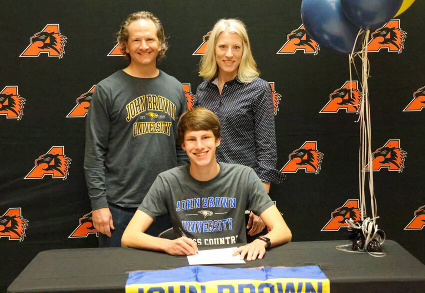 Henry Zedler signed with John Brown University to run cross country. He is shown with Sarah and Doug Zedler.