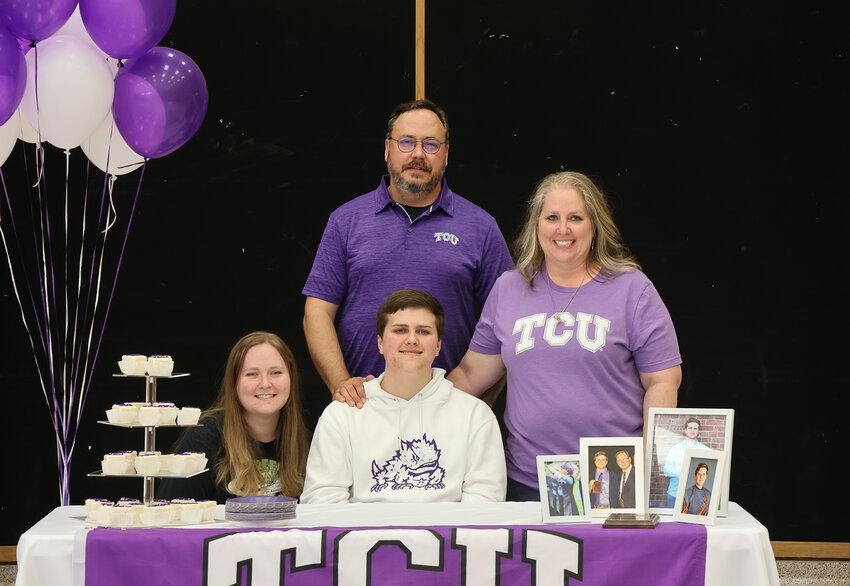 Jack Grimm signed with TCU in band. He is shown with Jennifer and Eric Grimm and Madeline Grimm.