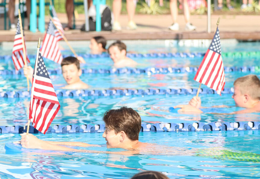 Swimmers celebrate with flags during the Weatherford Wild Swim Meet this past Saturday.