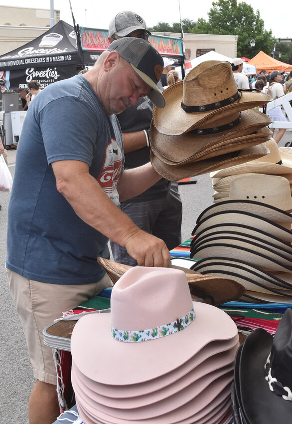 Butch King of Weatherford looks for just the right hat.