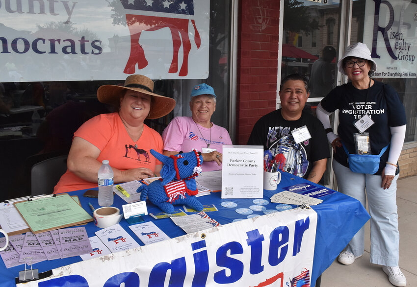 Christine Youngblood, Judy Kotrlik, Norman Score, and Belinda Barbosa register voters in front of the Parker County Democrats office.