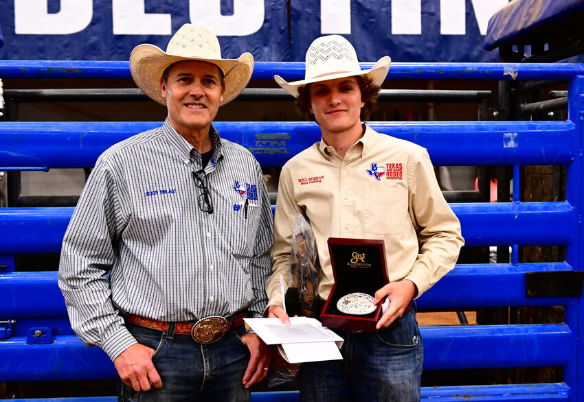 Texas High School Rodeo President Ken Bray presents the award for winning rhe state boys cutting championship to Will Bushaw.
