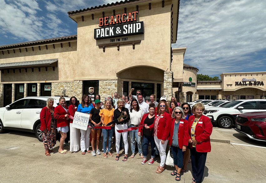Bearcat Pack & Ship owner Danelle Weaver completes the ribbon cutting by the East Parker County Chamber of Commerce at her new business on Thursday, July 13.