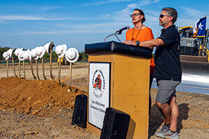 Co-Chairs of the Aledo Growth Committee, Kelli Stumbo and Dan Reilley take to the podium during the groundbreaking ceremony for the new Lynn McKinney Elementary School on Thursday, July 20.