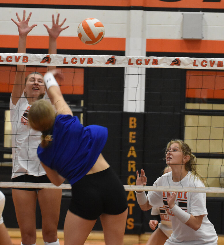 Haley Lowe goes up for a block at the net in scrimmage action against Weatherford on Aug. 5. ALso pictured is Vivian Parker.