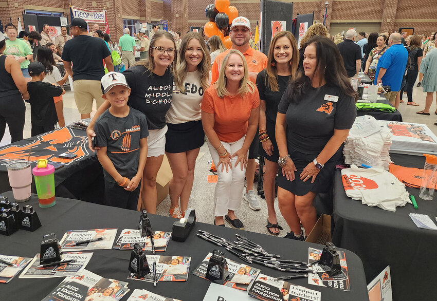 At the Aledo Education Foundation booth are (front row, from left) Kaden Rice, Paige Rice, Valerie Kerr, Dustin Parker, and Jill Keith, and (back row) Matt Sudderth and Ashley Hodo.