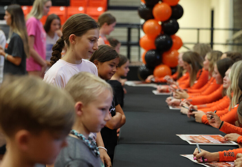 Future Ladycats and Bearcats seek autographs from varsity players.
