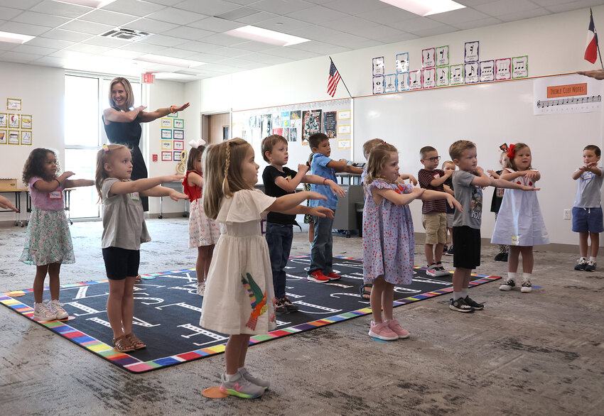 Aledo ISD Superintendent Dr. Susan Bohn joins in class activities during the first day of School at Walsh Elementary School.