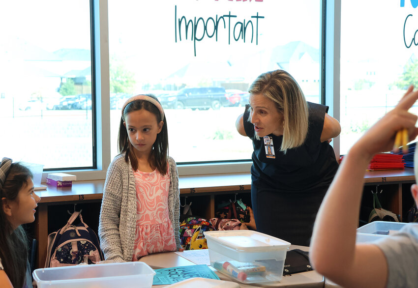 Aledo ISD Superintendent Dr. Susan Bohn joins in class activities during the first day of School at Walsh Elementary School.