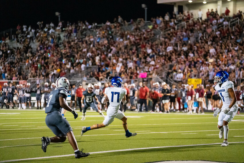 Colton McClure catches a pass on a crossing pattern against Keller Central. McClure had five catches for 44 yards.