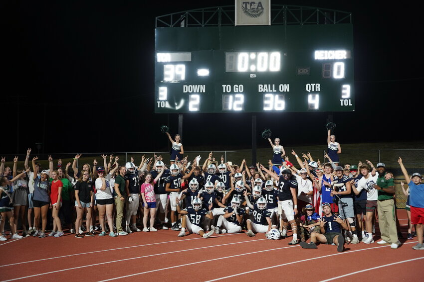 Fans celebrate with the team after the Trinity Christian Eagles got their first win in their new stadium, defeating Bishop Reicher 39-0 on Friday, Sept. 1.