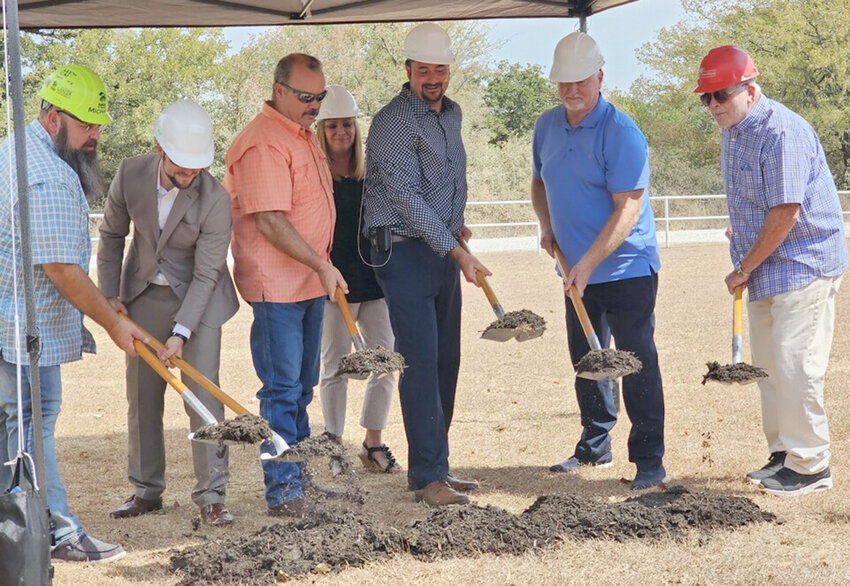 Leaders of New Faith Baptist Church turn dirt for the new construction project.
