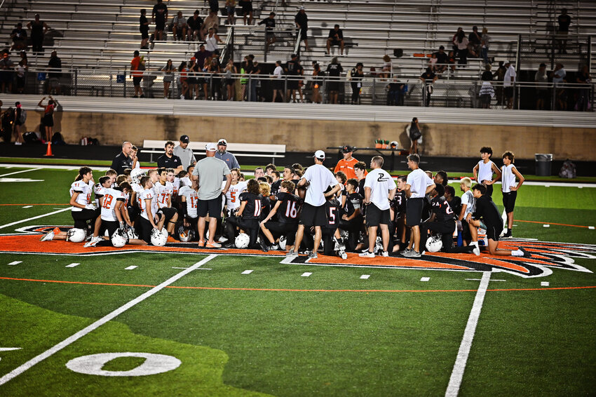 Aledo Middle School and McAnally Middle School football teams kneel after the football game on Oct. 3. MMS A team defeated AMS A team 14-8. 