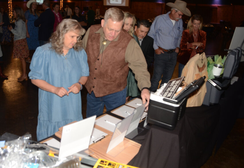LeAnn and Darrel Russell look over the many silent auction items.