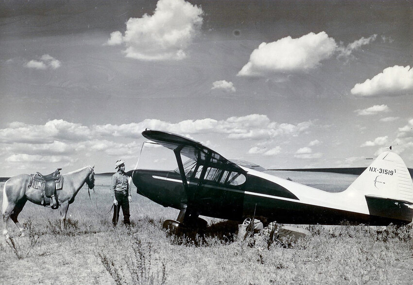 Bob Rothel is shown with a Stinson airplane that landed on the ranch.