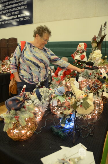 Gladys Spaulding is enchanted by sparkling lighted gift baskets and table settings.