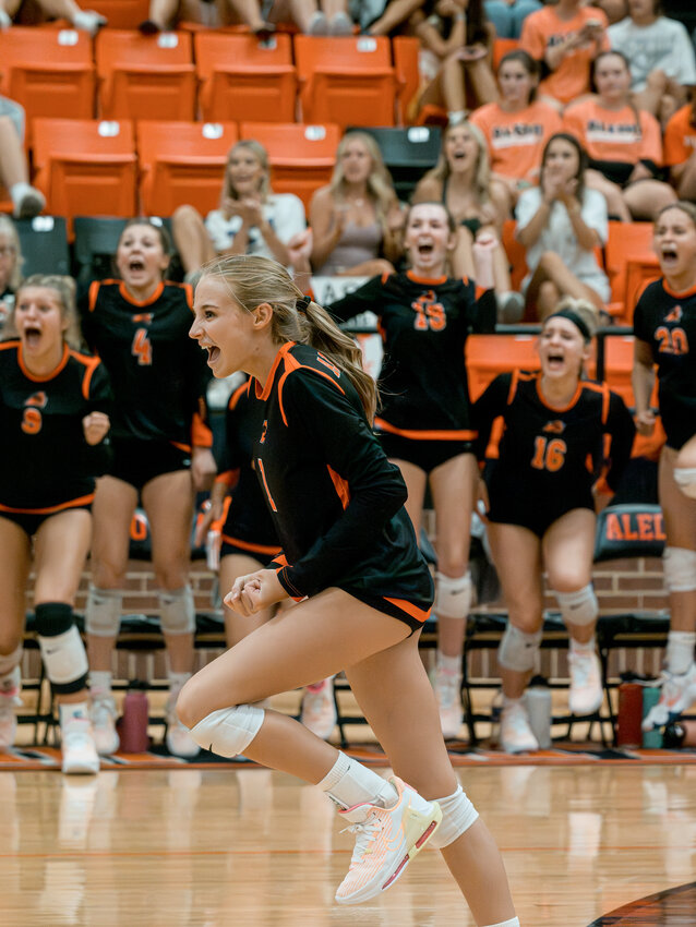 Kenrie Pruitt celebrates a point for the Ladycats earlier in the season while the Aledo bench cheers on their teammates in the background.