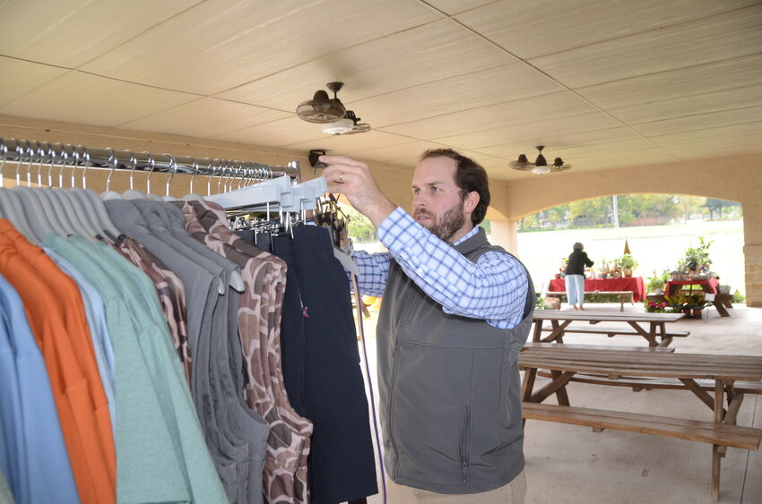 Austin Henyon readies his booth, Hen House Clothing.