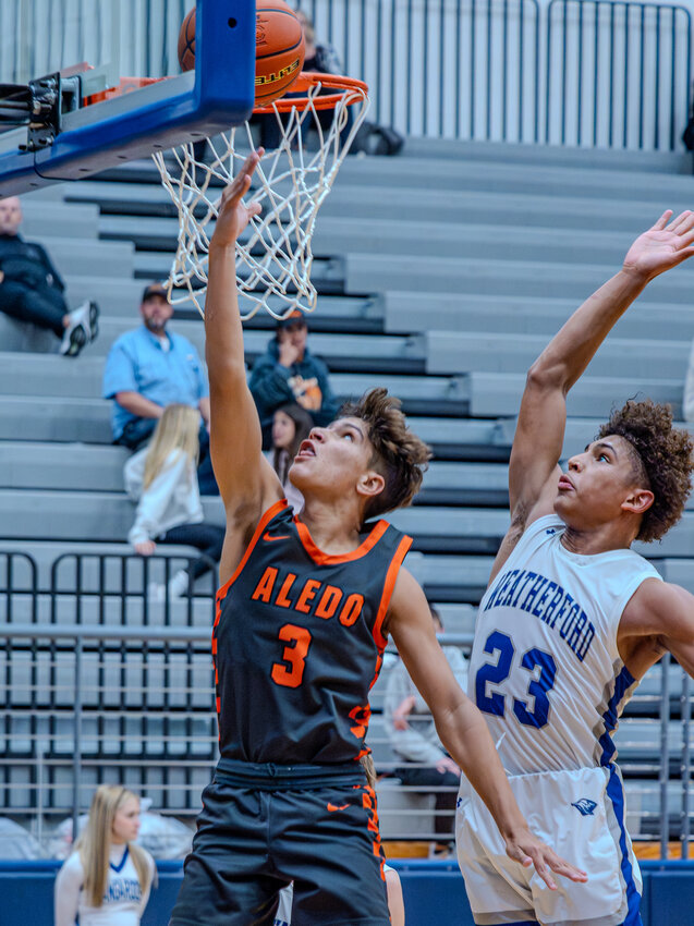 Joaquin Pacheco plays a layup off the glass on a fastbreak as the Bearcats defeated Weatherford, 55-51. Pacheco led Aledo in scoring with 23 points.