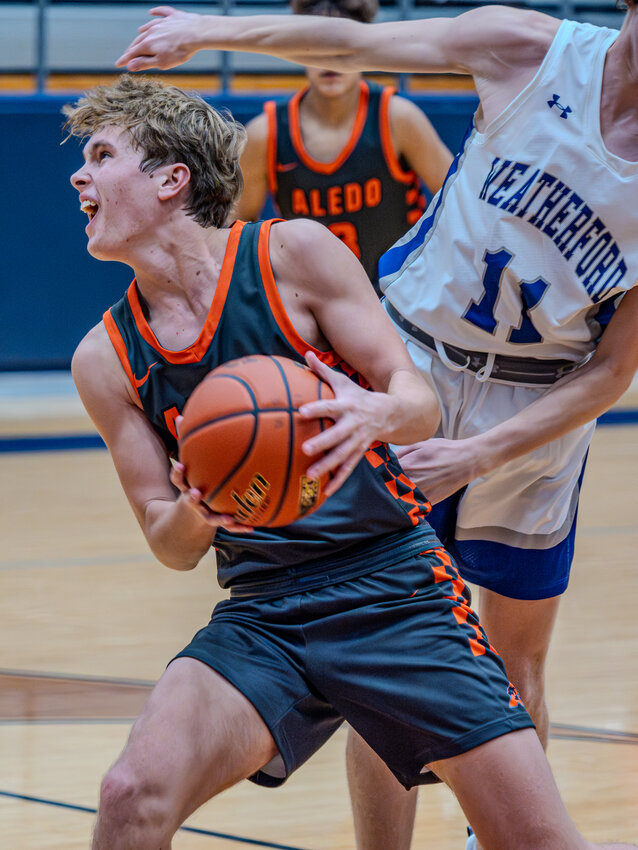 Owen Peterson reacts after being fouled by a Roos defender during varsity hoops action in Weatherford on Friday, Nov. 17. Aledo earned a hard-fought victory to pick up their first win of the season, 55-51.