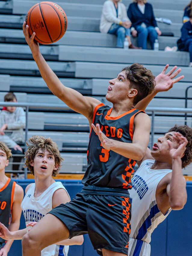 Joaquin Pacheco goes up for a layup while being pursued by a Weatherford defender during the Bearcats win on Nov. 17. On Tuesday, Nov. 28, Pacheco led Aledo in scoring as the Bearcats fell to Midlothian Heritage, 64-58.
