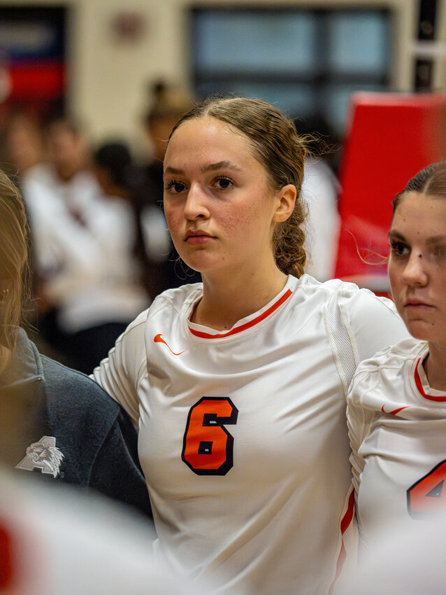 Ava Reding listens to Coach Claire Gay during a pre-match huddle before the bi-district match against Northside. Reding eanred All-District honors this season as Server of the Year.