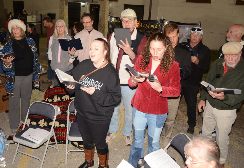 The Aledo United Methodist Church choir sets the mood with Christmas carols.