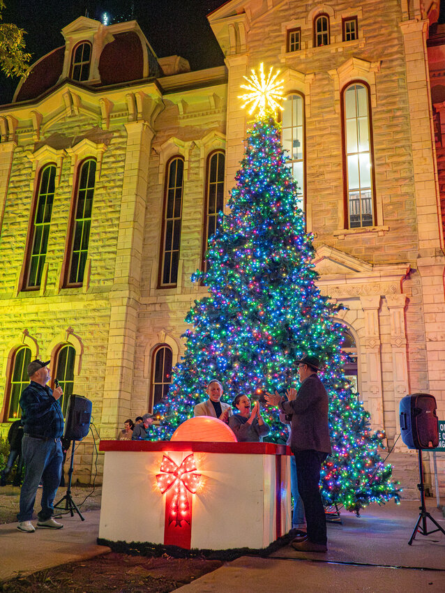 Annetta mayor, Sandy Roberts, and Weatherford mayor, Paul Paschall, celebrate the lighting of the tree at the courthouse in Weatherford on Saturday, Dec. 2.