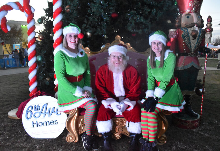 Santa Claus and his two helpers, Tosya Kidd and Holly Elrod, provided photos and candy courtesy of 6th Ave. Homes.