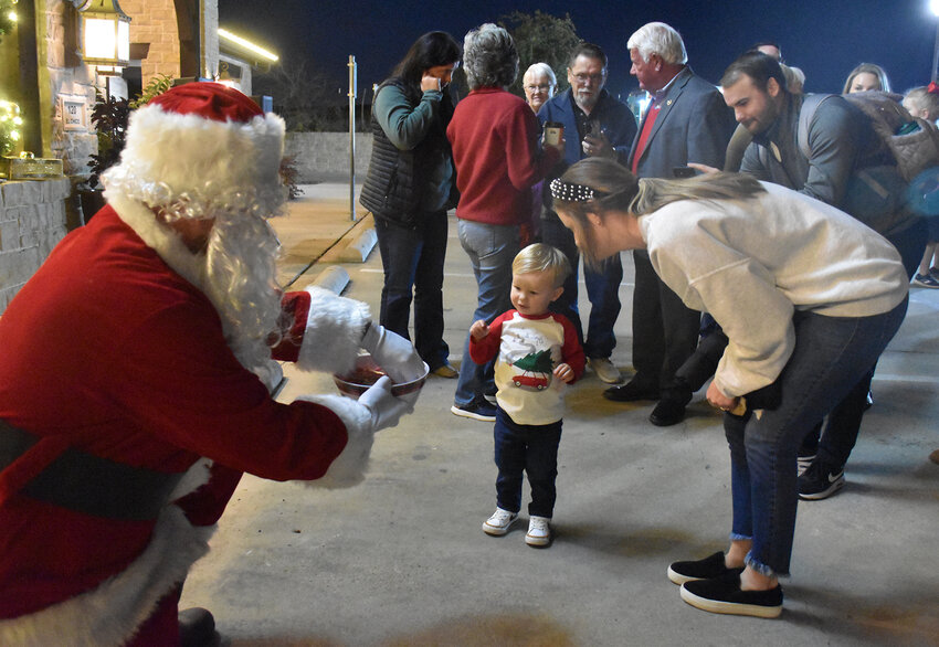 Rhett Hill warily approaches Santa for a candy cane.