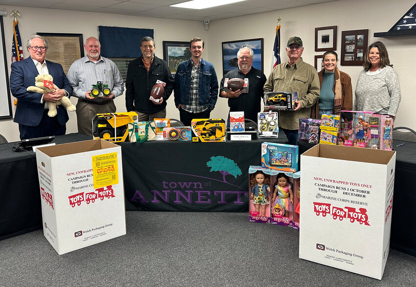 Annetta City Council members Danny Coffman, Bruce Pinckard, and Shane Mudge, WebEx facilitator Eric Heaton, council members Kent Stasey and Jim Causey, Mayor Sandy Roberts, and City Secretary Jamee Long gave a jump start to toy collections in Annetta.